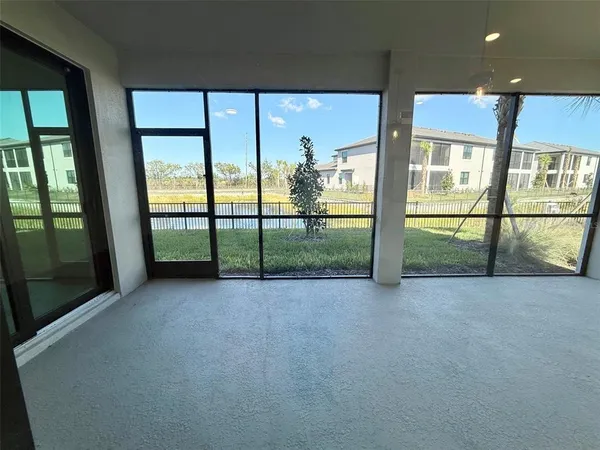 an empty room with sliding door and mountain view