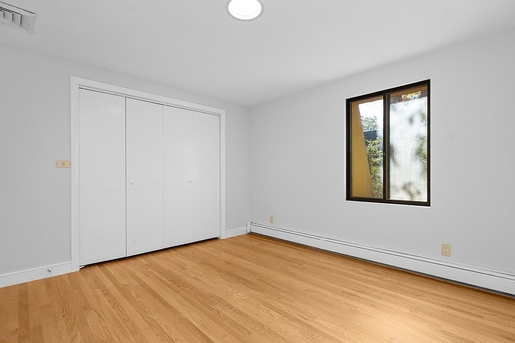 30 Colby Road Wellesley, MA 02482 - Photo 23 of 31 a view of an empty room with wooden floor and a window
