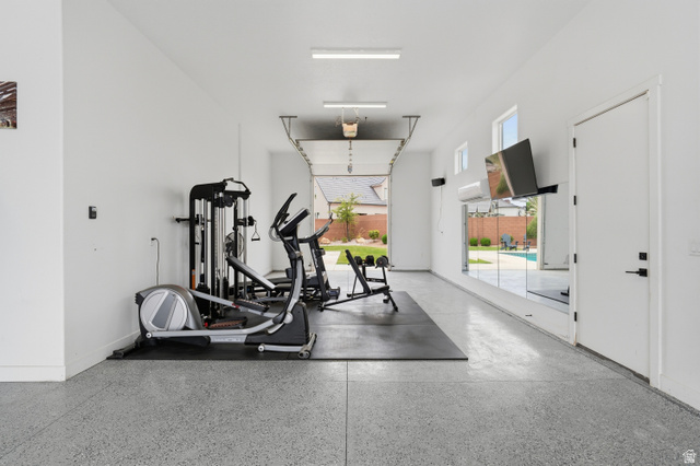 2278 Tawny Ridge Circle St. George, UT 84790 - Photo 50 of 61 Spacious garage conversion featuring a smooth epoxy floor, white painted walls, and overhead fluorescent lighting.