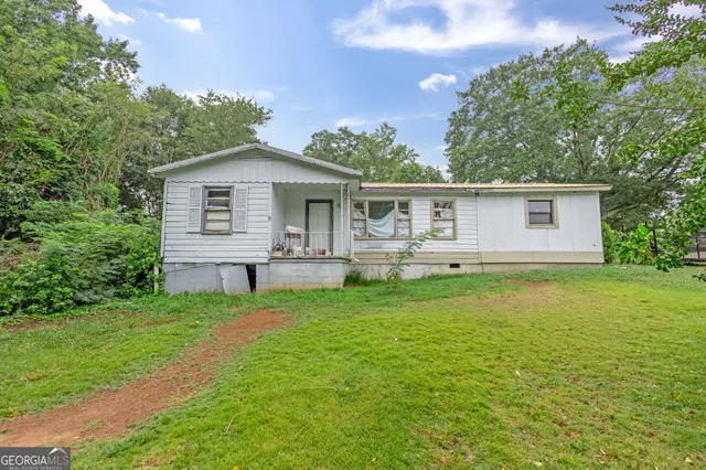 a front view of house with yard and green space