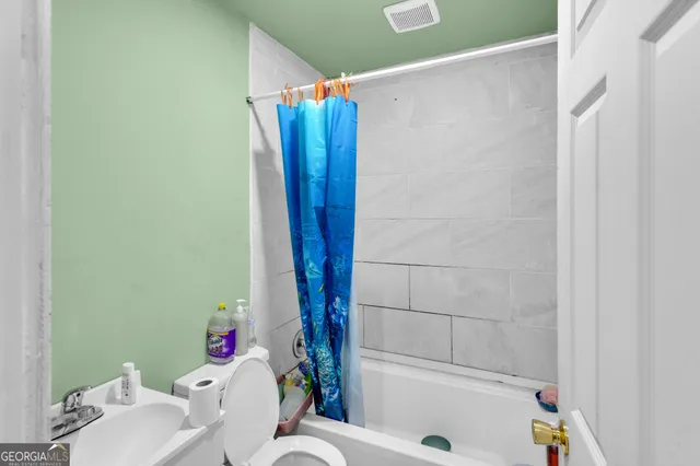 a bathroom with a bathtub and shower