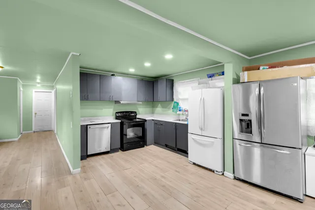 a kitchen with stainless steel appliances a refrigerator sink and microwave