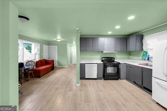 a kitchen with kitchen island granite countertop a sink a counter top space and stainless steel appliances