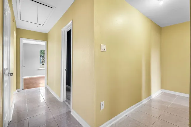 a view of a hallway with a living room