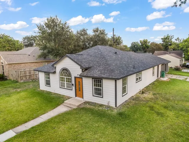a view of a house with a yard balcony and a tub