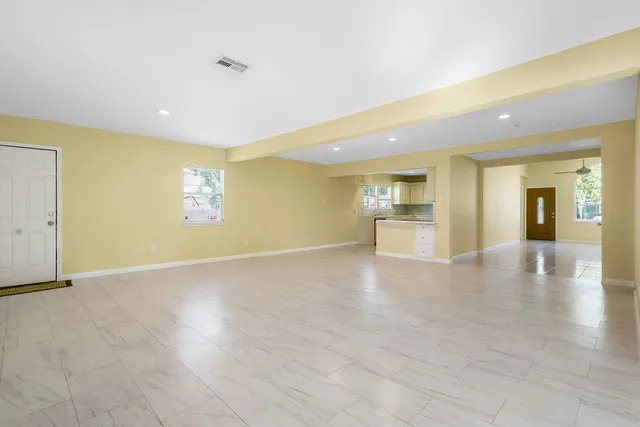 a view of a kitchen with a sink and a refrigerator