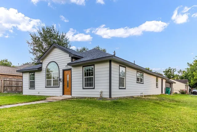 a front view of a house with a garden