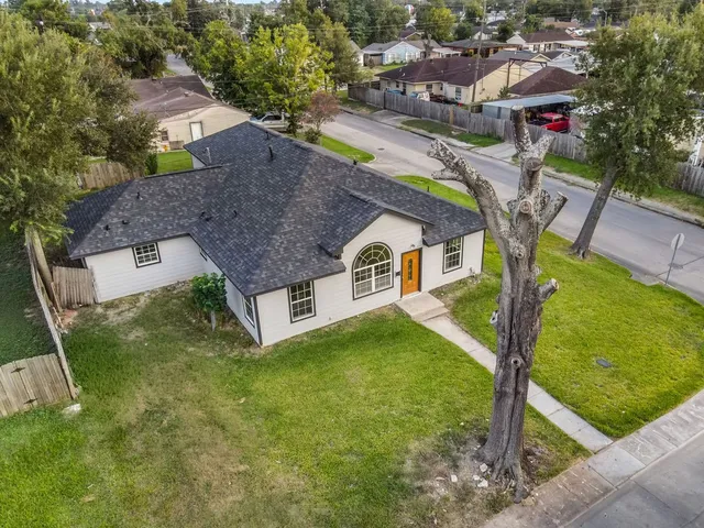an aerial view of residential houses with yard