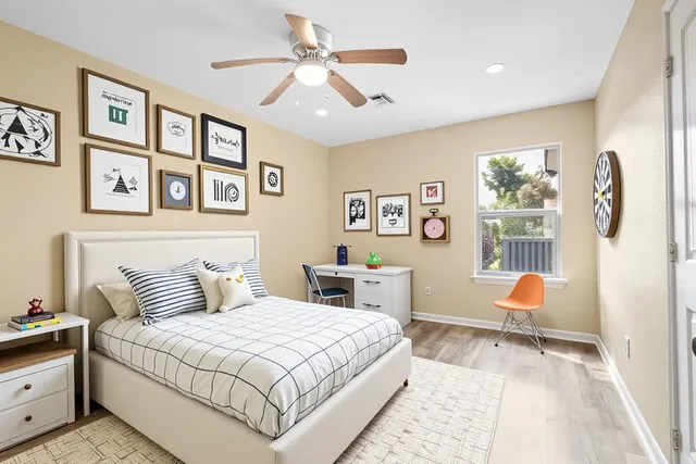 a bedroom with a bed and a chandelier