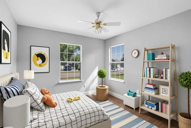 a bedroom with a bed and a wooden floor