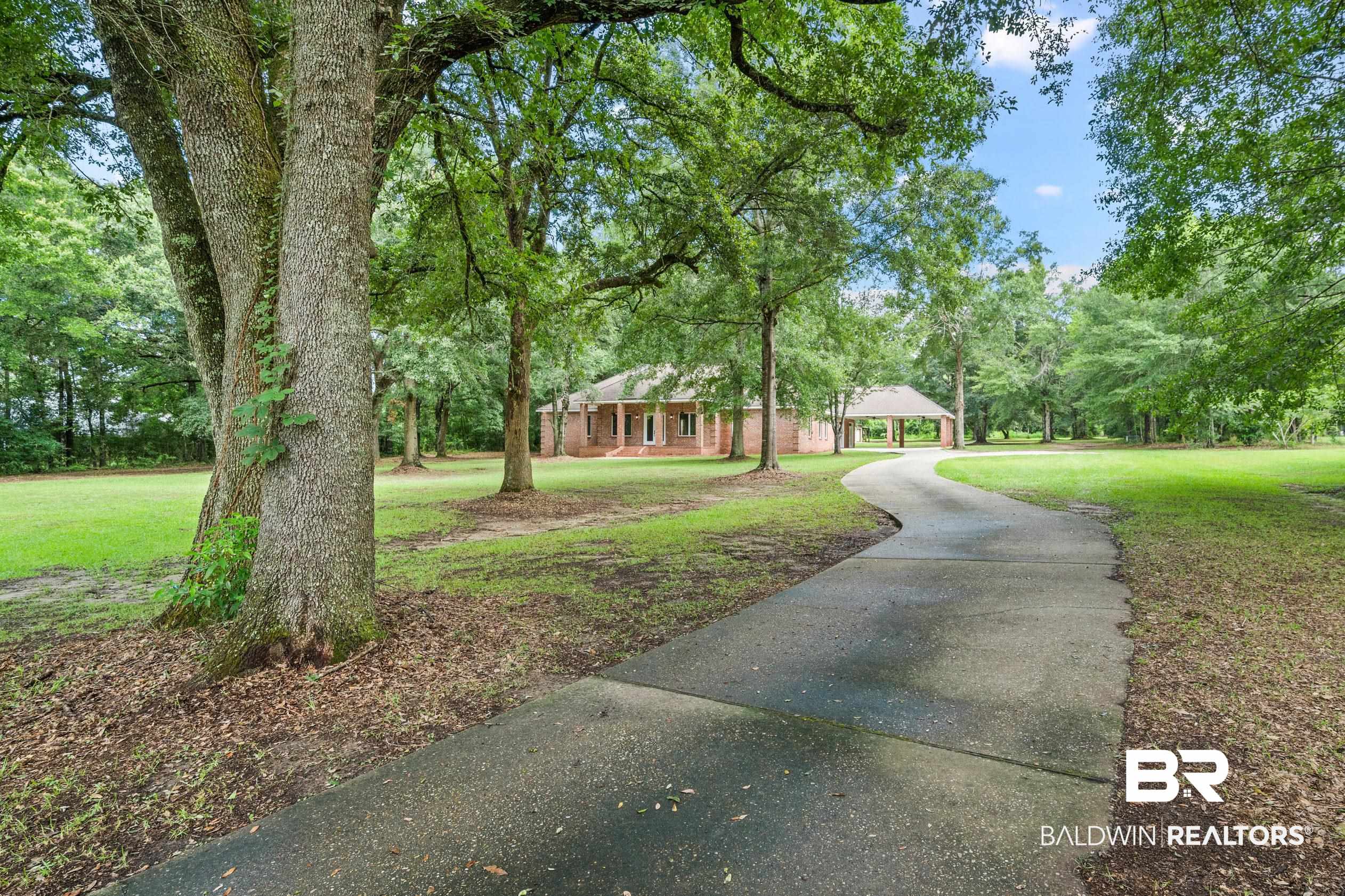 15031 Timber Ridge Drive Loxley, AL 36551 - Photo 5 of 43 View of front facade featuring a front yard
