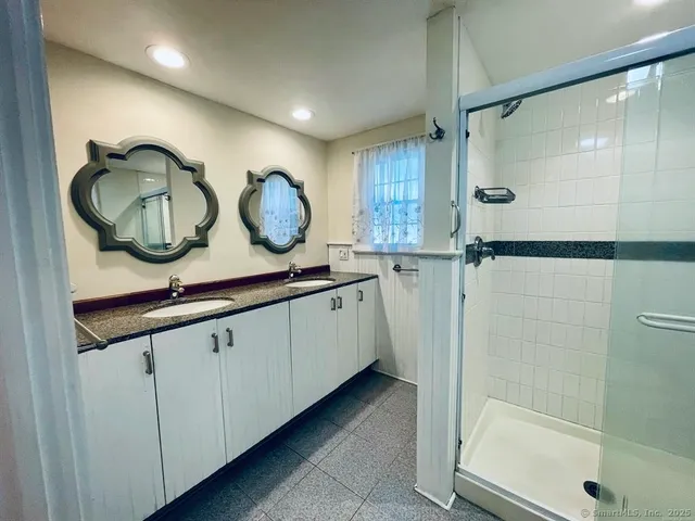 a bathroom with a double vanity sink and a mirror