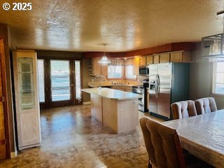 443 9th Street Metolius, OR 97741 - Photo 15 of 22 a kitchen with refrigerator and cabinets