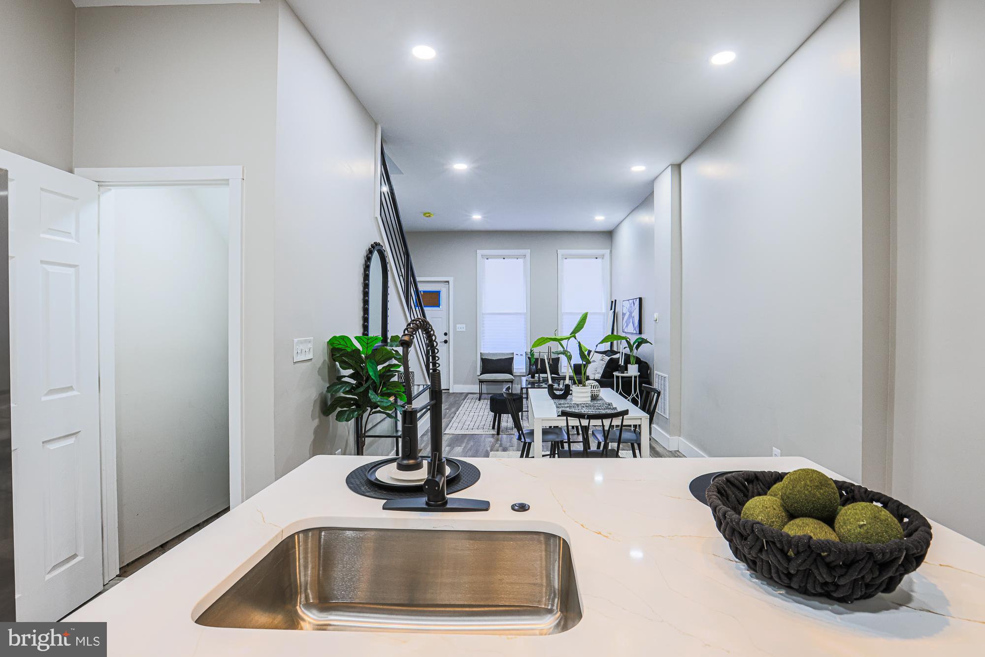 1728 Ruxton Avenue Baltimore, MD 21216 - Photo 42 of 43 a kitchen with a sink and a potted plant