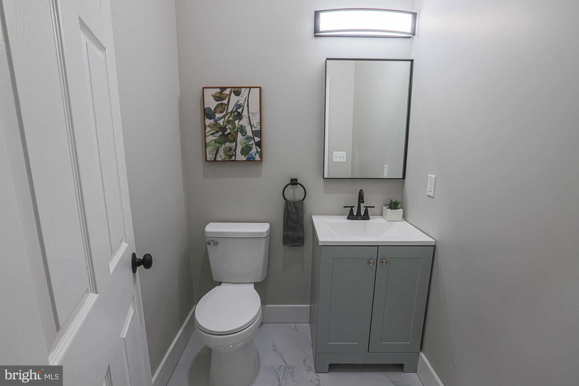 1728 Ruxton Avenue Baltimore, MD 21216 - Photo 17 of 43 a bathroom with a toilet sink and mirror