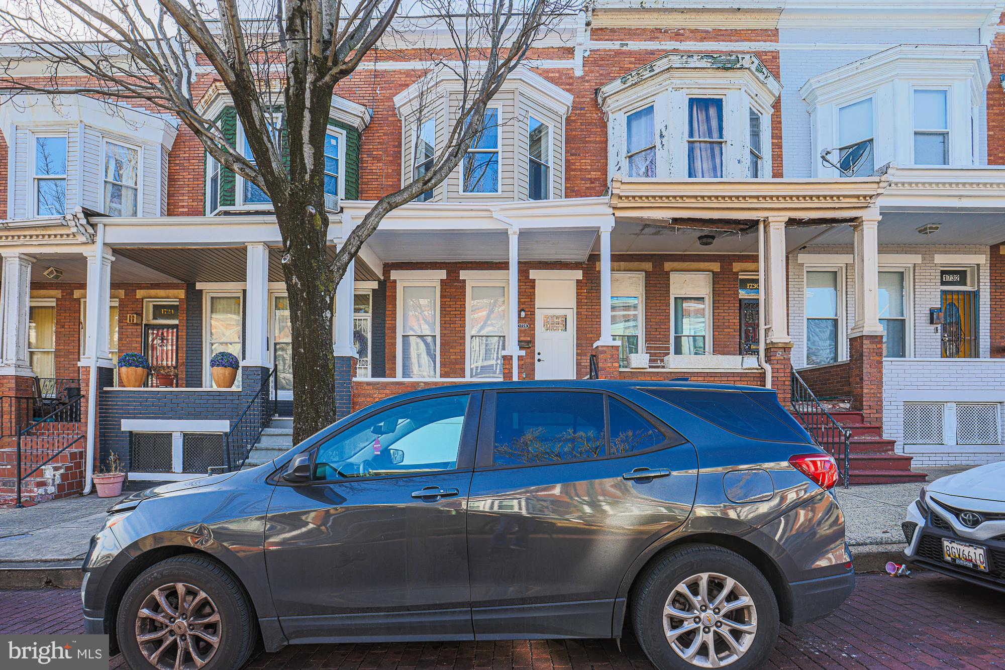 1728 Ruxton Avenue Baltimore, MD 21216 - Photo 2 of 43 a front view of a house with parking space