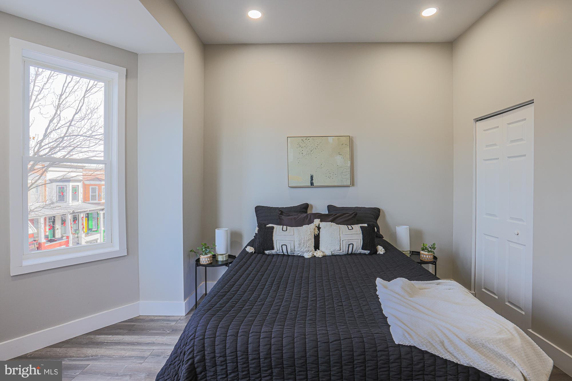 1728 Ruxton Avenue Baltimore, MD 21216 - Photo 21 of 43 a bedroom with a bed and wooden floor