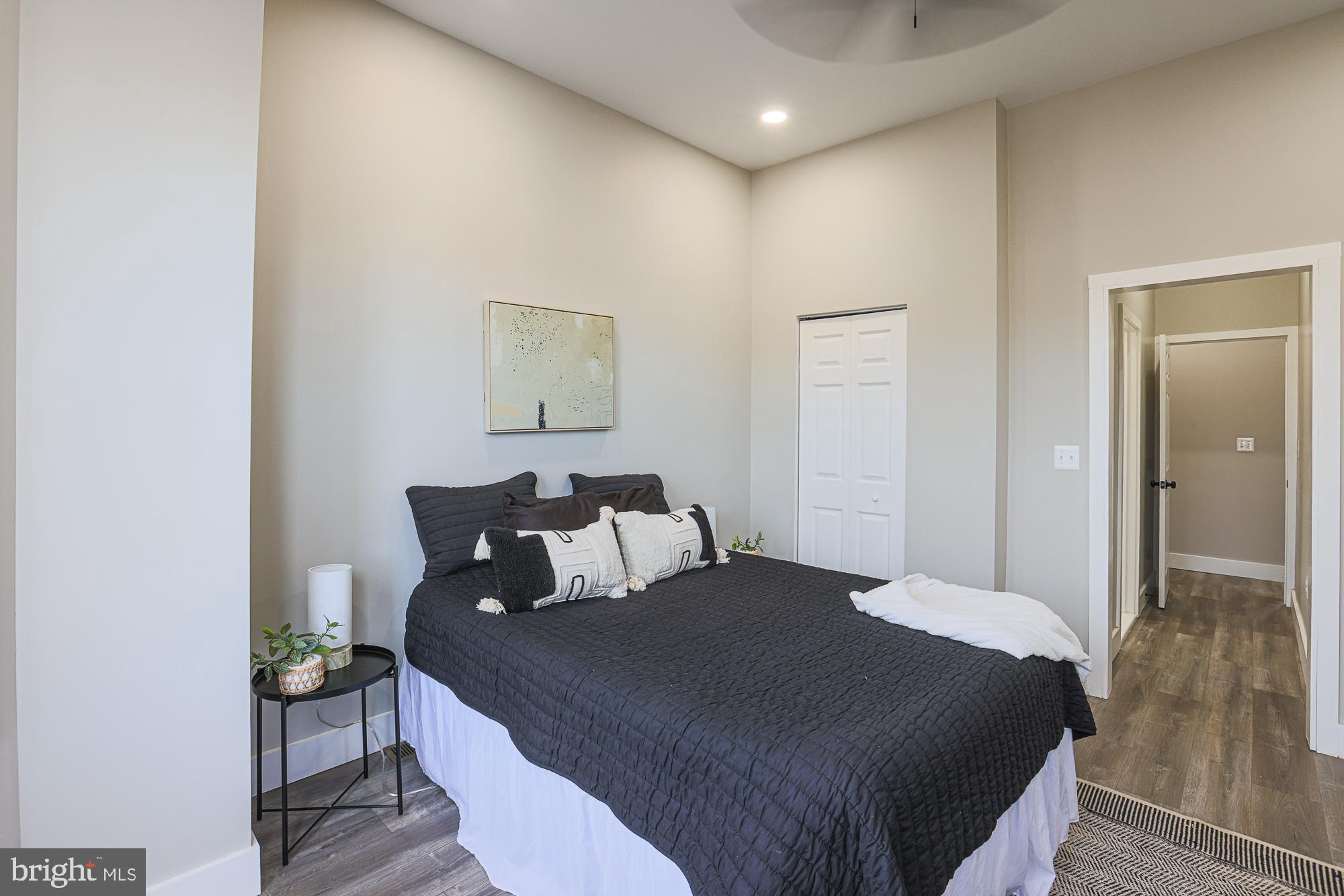 1728 Ruxton Avenue Baltimore, MD 21216 - Photo 23 of 43 a bedroom with a bed and wooden floor
