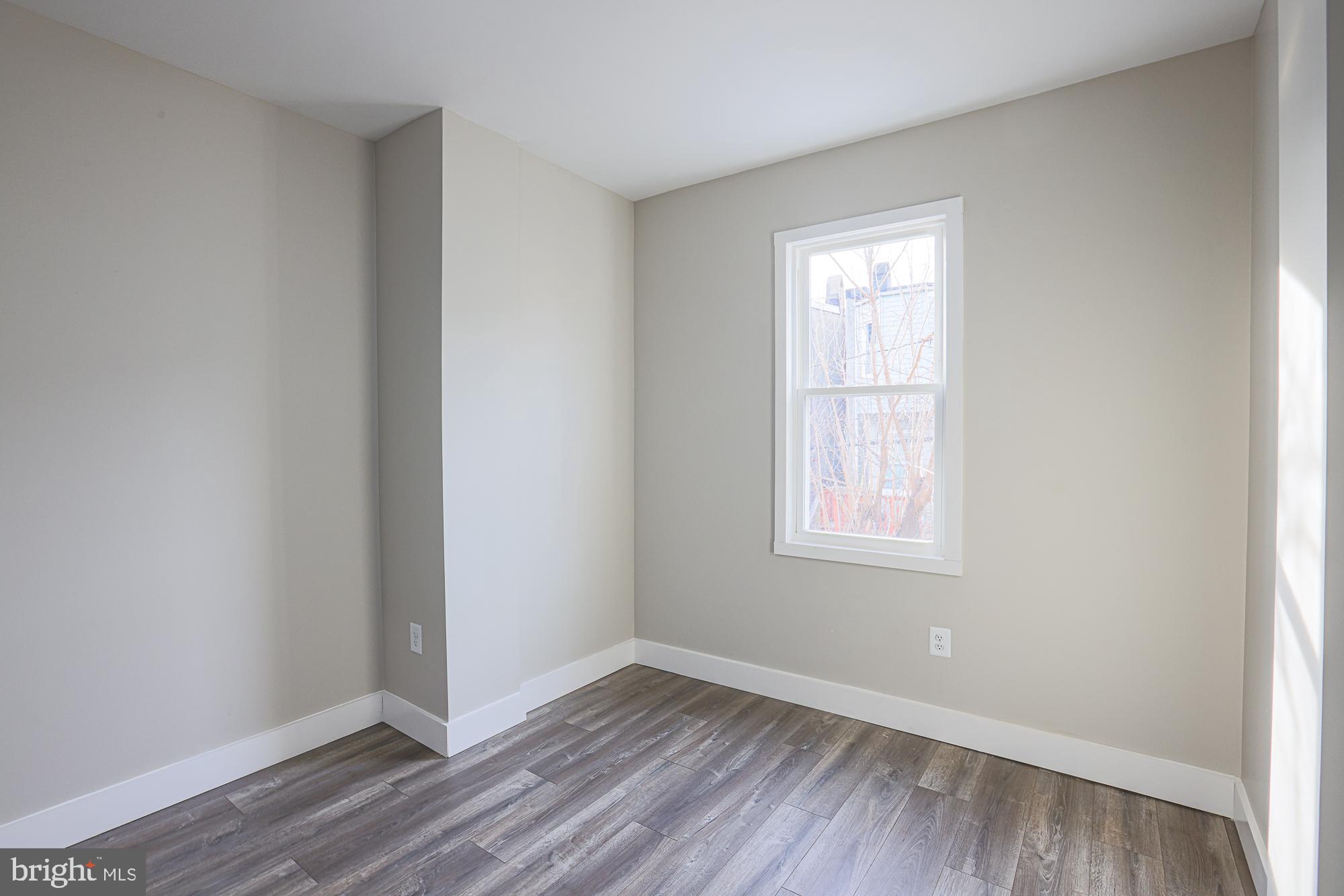 1728 Ruxton Avenue Baltimore, MD 21216 - Photo 27 of 43 an empty room with wooden floor and windows