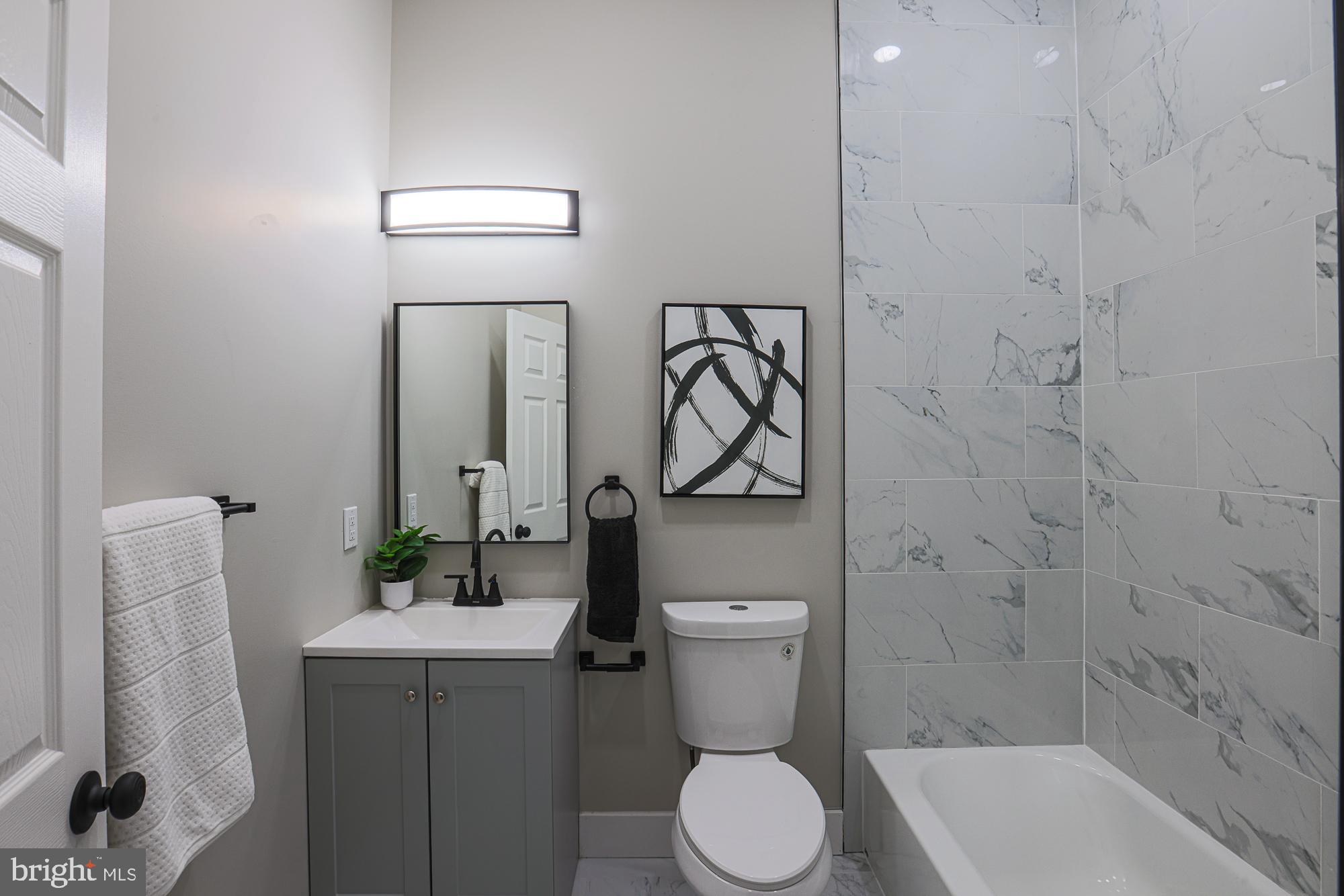 1728 Ruxton Avenue Baltimore, MD 21216 - Photo 28 of 43 a bathroom with a toilet sink and shower