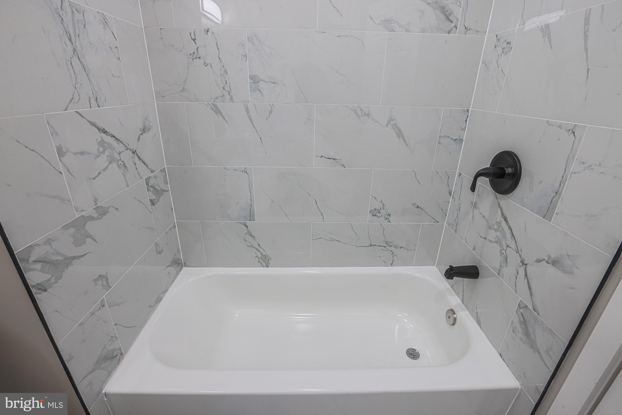 1728 Ruxton Avenue Baltimore, MD 21216 - Photo 29 of 43 a bathroom with a bathtub