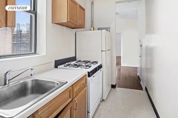 a kitchen with a sink stove and refrigerator