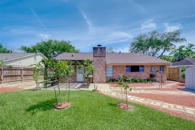a house view with a sitting space and garden
