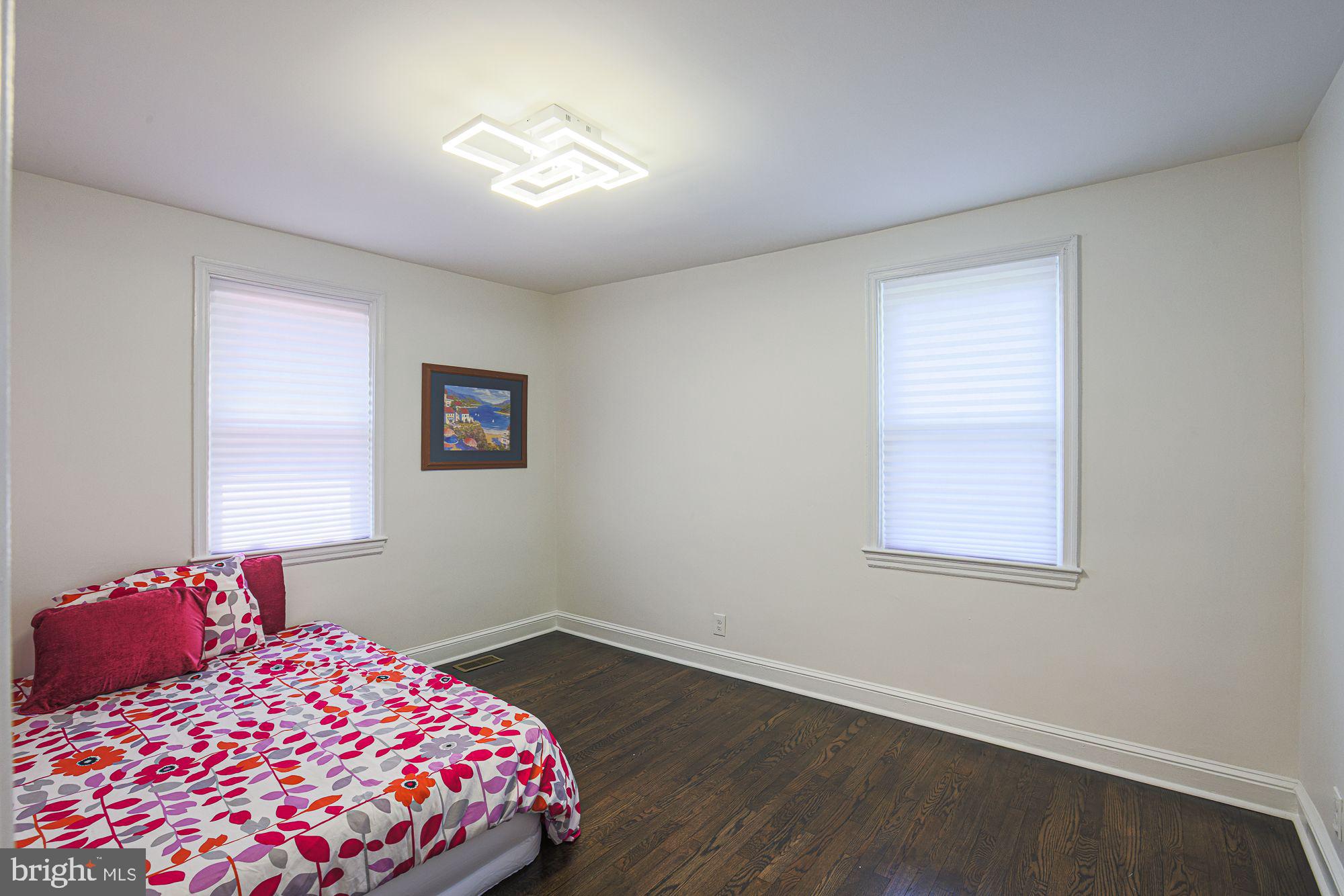 6203 Hopeton Avenue Baltimore, MD 21215 - Photo 11 of 18 a bedroom with a bed and a window