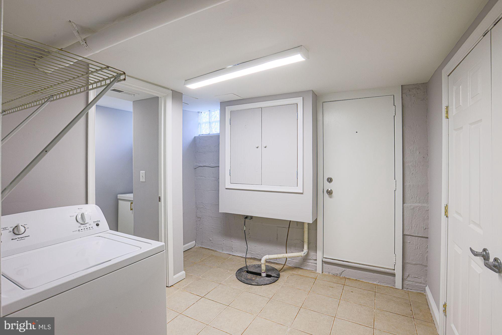 6203 Hopeton Avenue Baltimore, MD 21215 - Photo 13 of 18 a view of a bathroom with a sink and mirror