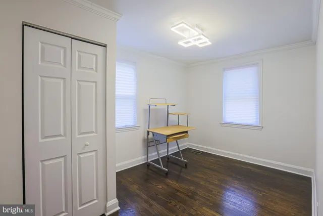 a view of a room with wooden floor lounge chair and windows