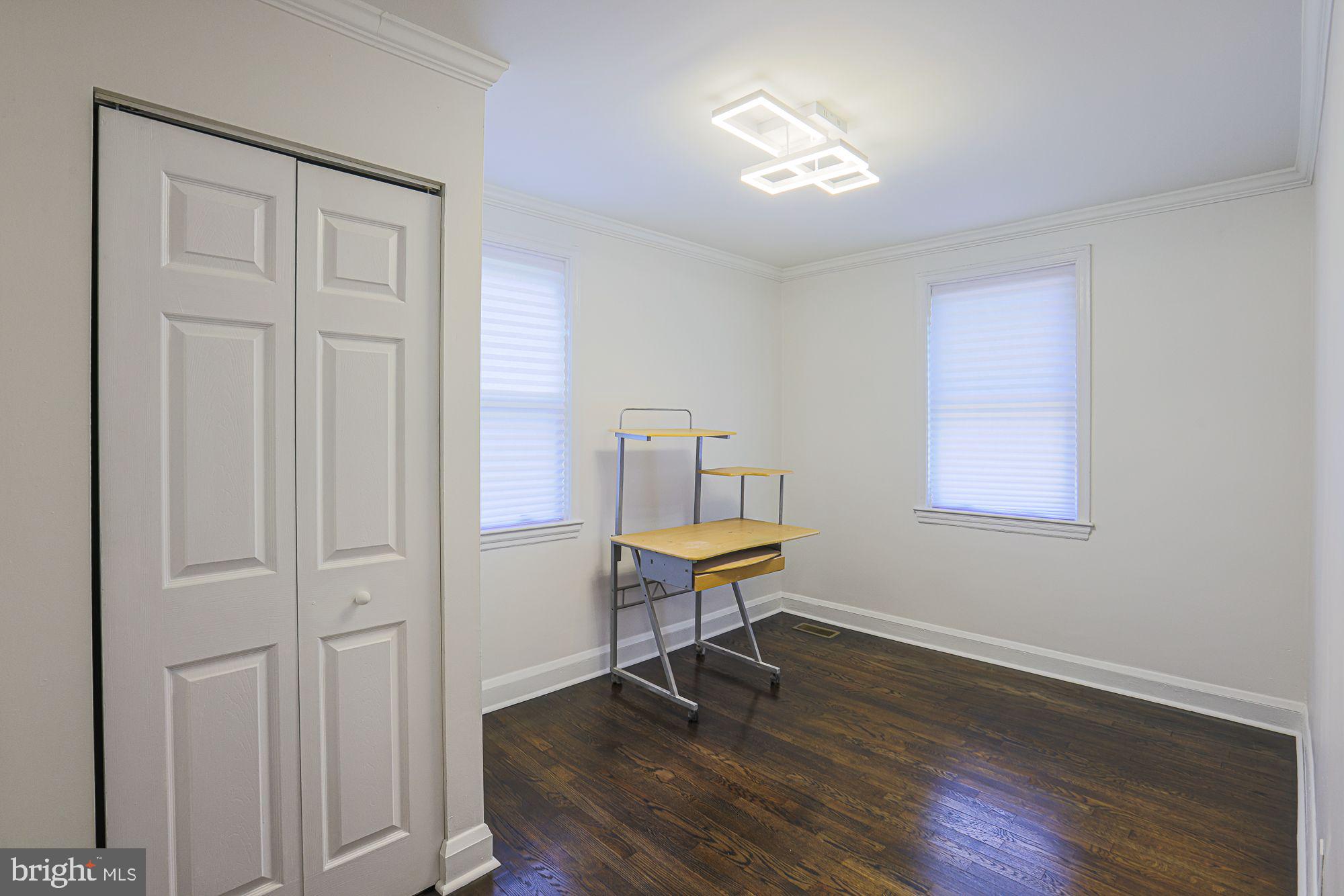 6203 Hopeton Avenue Baltimore, MD 21215 - Photo 14 of 18 a view of a room with wooden floor lounge chair and windows