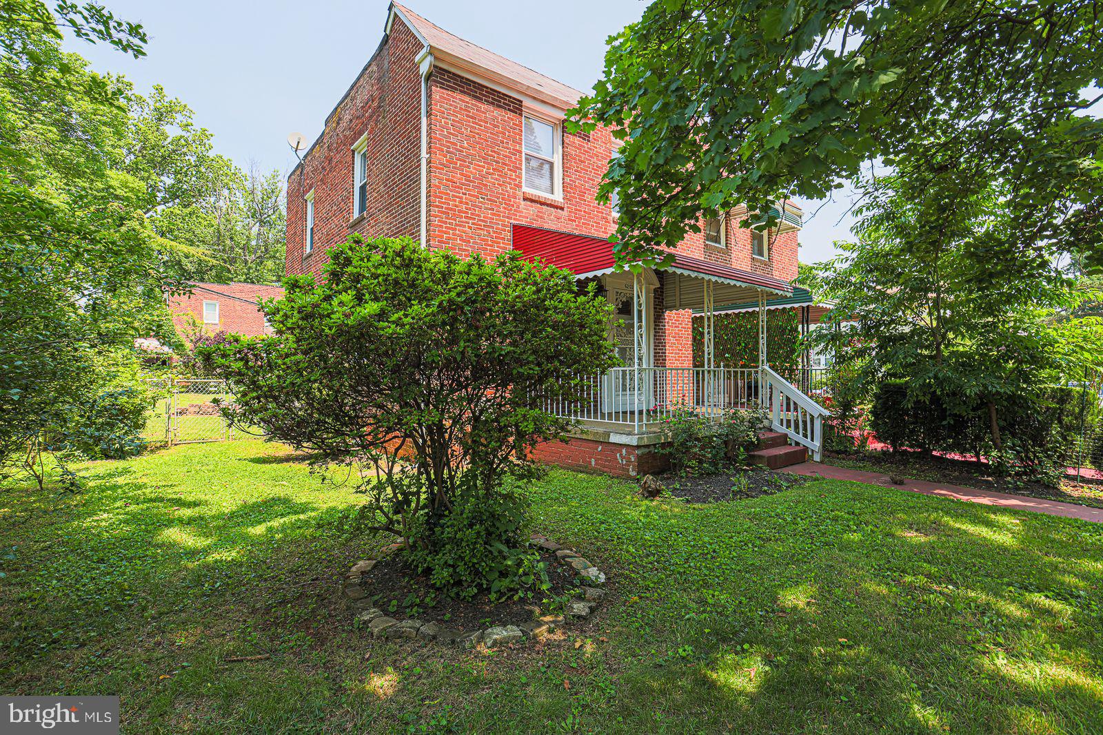 6203 Hopeton Avenue Baltimore, MD 21215 - Photo 2 of 18 a front view of a house with garden