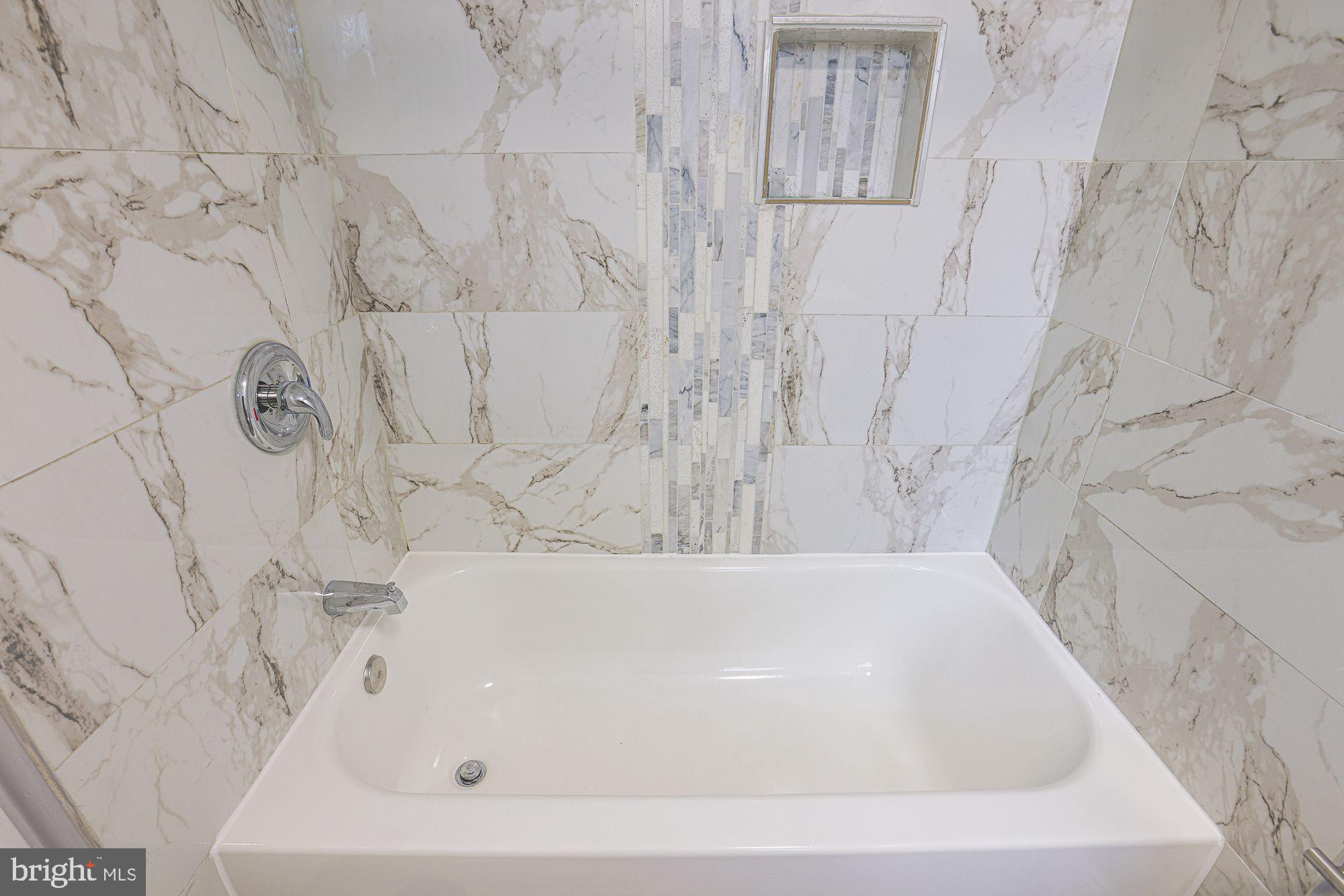 6203 Hopeton Avenue Baltimore, MD 21215 - Photo 9 of 18 a bathroom with a bathtub