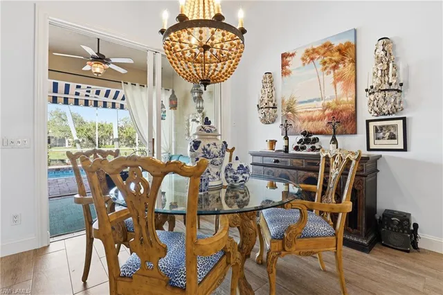 a view of a dining room with furniture a chandelier and wooden floor
