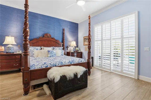 a bedroom with a large bed and a window