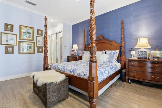 a bedroom with a bed a lamp and window