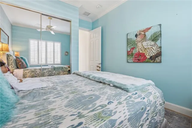 a bedroom with a large bed and a painting on the wall