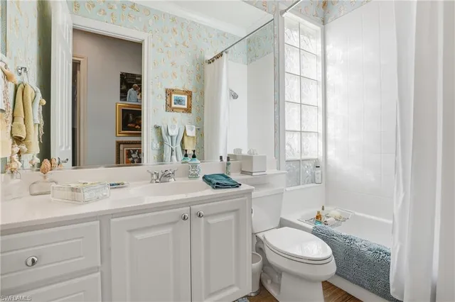 a bathroom with a granite countertop sink toilet and mirror
