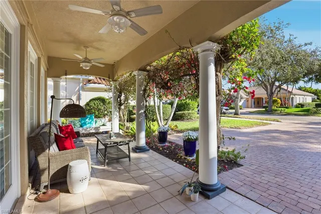 a building outdoor space with patio furniture and potted plants