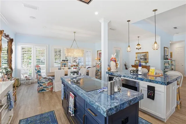 a kitchen with stainless steel appliances granite countertop a stove and a living room