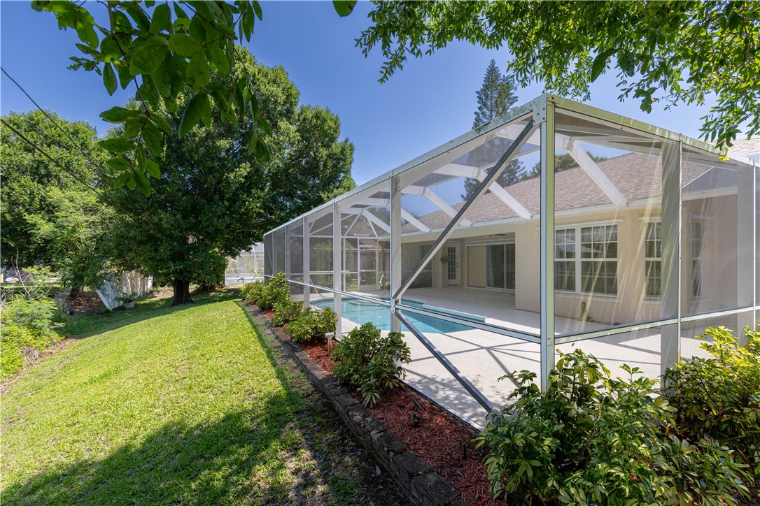 414 Ash Street Sebastian, FL 32958 - Photo 33 of 36 a house with green field in front of it