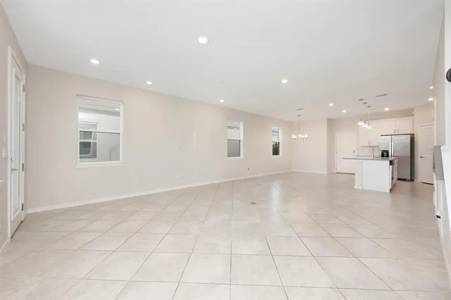 a view of a livingroom with a ceiling fan & entryway