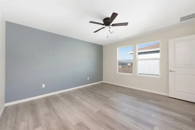 a bathroom with a granite countertop sink mirror and toilet