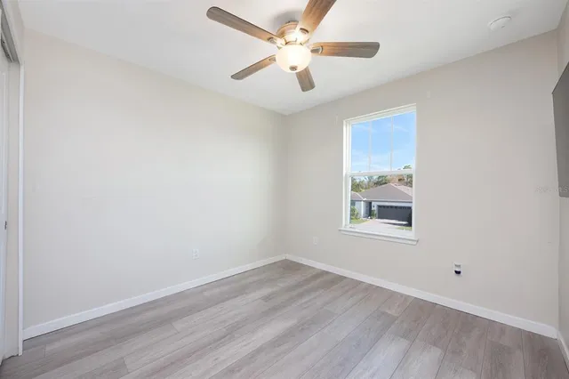 a bathroom with a granite countertop sink a toilet and a bathtub
