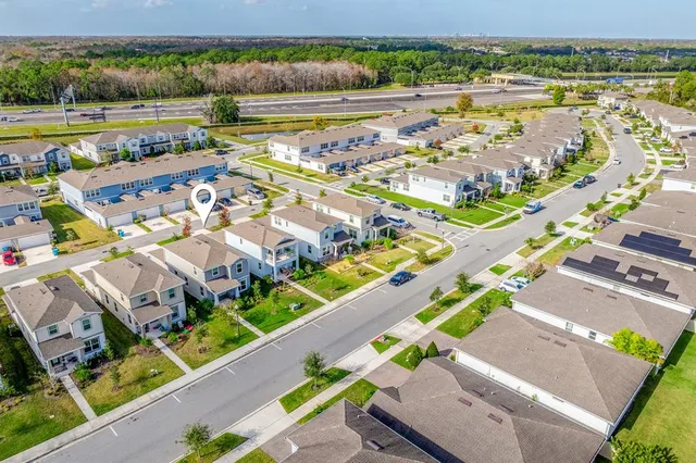 a view of multiple houses with a swimming pool