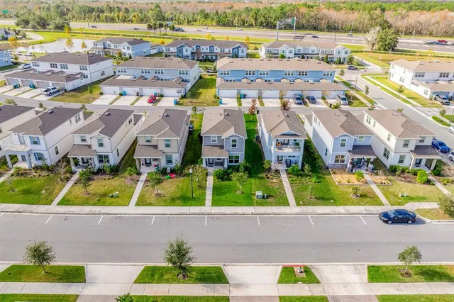 an aerial view of residential houses with outdoor space