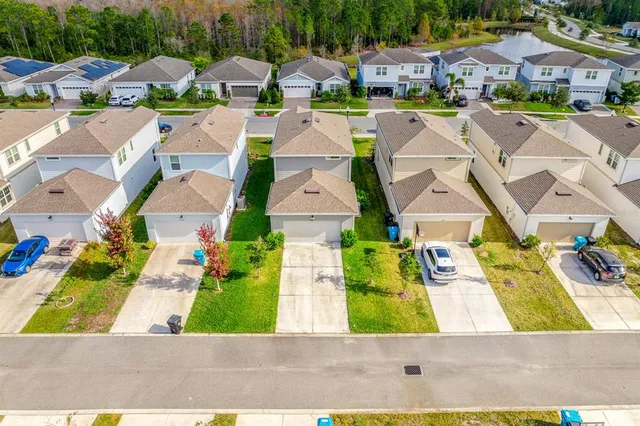 an aerial view of residential building and lake