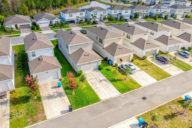 an aerial view of residential building and lake