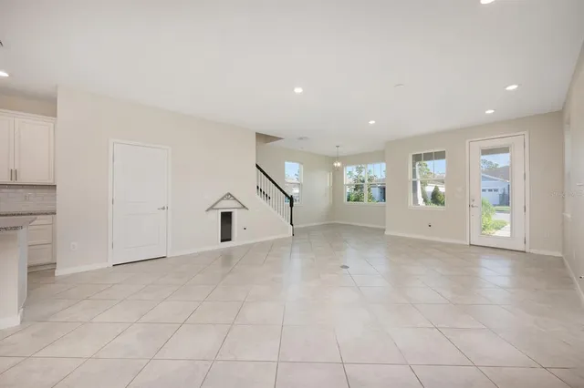 an empty room with entrance and windows