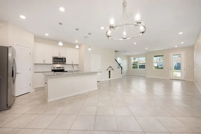 a view of a kitchen with a sink and refrigerator